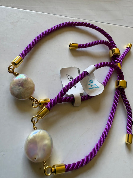 Bracelet: Pearl coin corded slider bracelets in goldtone.