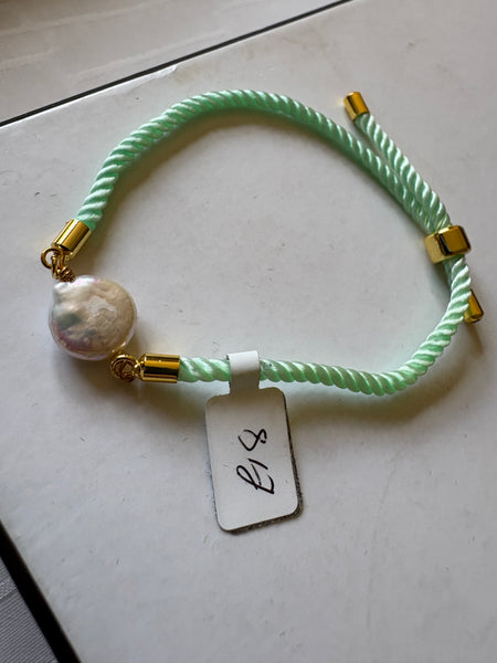 Bracelet: Pearl coin corded slider bracelets in goldtone.