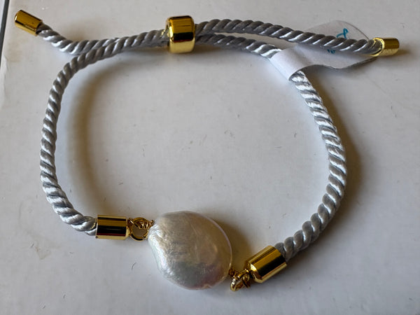 Bracelet: Pearl coin corded slider bracelets in goldtone.