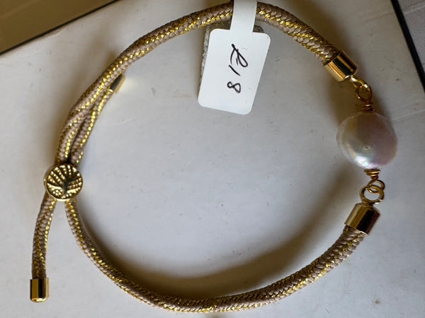 Bracelet: Pearl coin corded slider bracelets in goldtone.