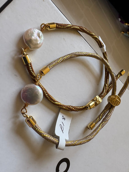 Bracelet: Pearl coin corded slider bracelets in goldtone.