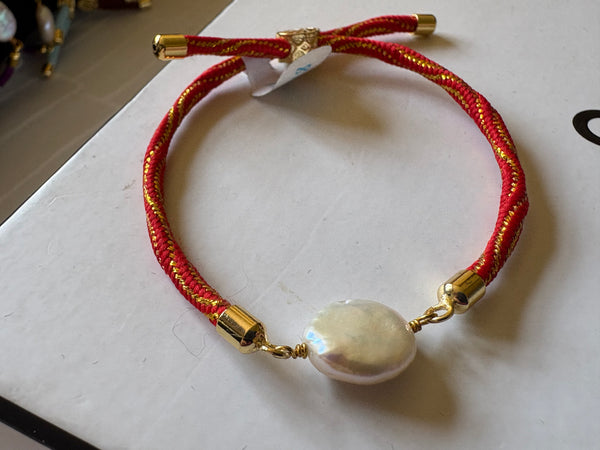Bracelet: Pearl coin corded slider bracelets in goldtone.