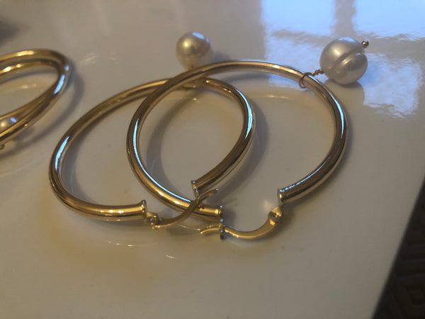 Earrings: Large gold plated  hoops with large ivory pearl